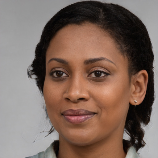 Joyful black young-adult female with medium  brown hair and brown eyes