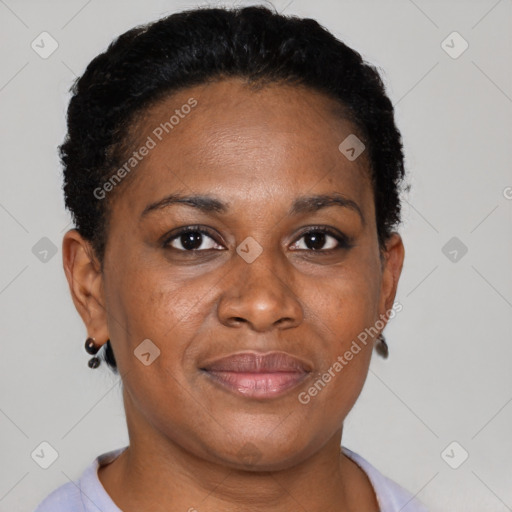 Joyful black adult female with short  brown hair and brown eyes