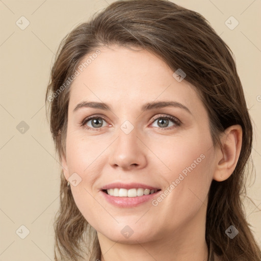 Joyful white young-adult female with long  brown hair and green eyes