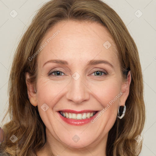 Joyful white young-adult female with long  brown hair and green eyes