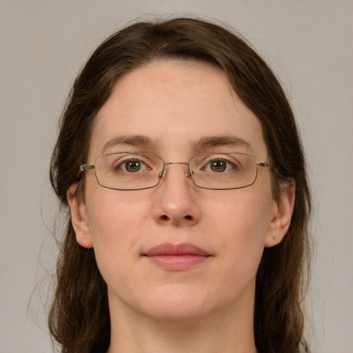 Joyful white adult female with medium  brown hair and green eyes