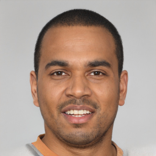 Joyful latino young-adult male with short  black hair and brown eyes