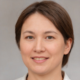 Joyful white adult female with medium  brown hair and brown eyes