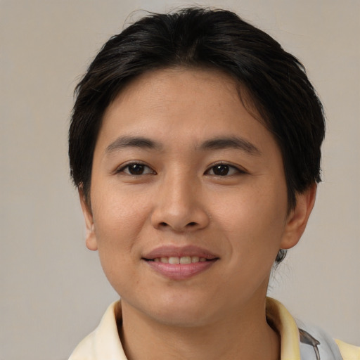 Joyful asian young-adult female with short  brown hair and brown eyes