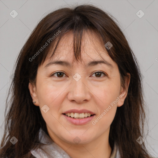 Joyful white adult female with long  brown hair and brown eyes