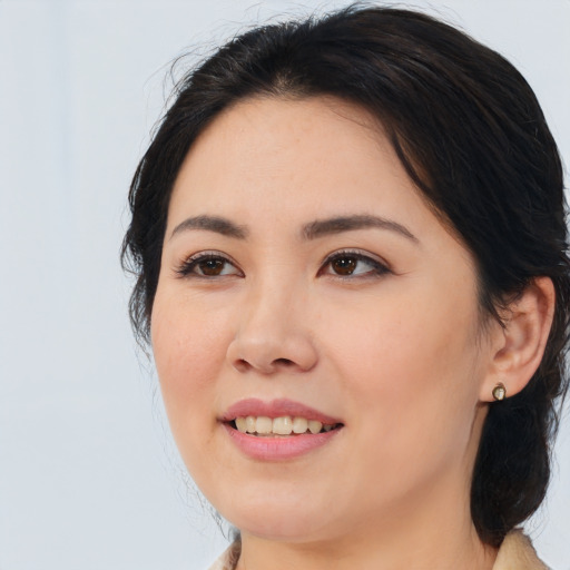 Joyful asian young-adult female with medium  brown hair and brown eyes