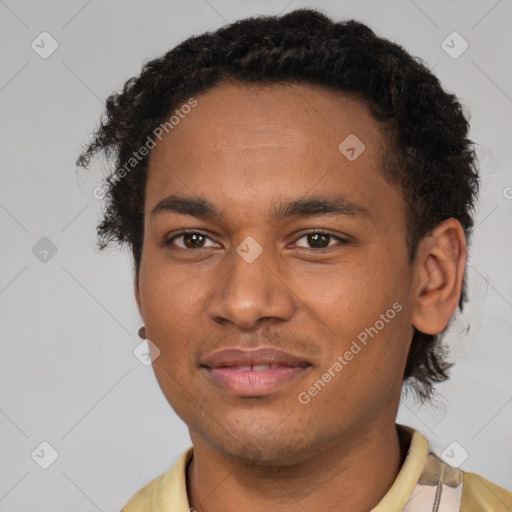 Joyful black young-adult male with short  brown hair and brown eyes