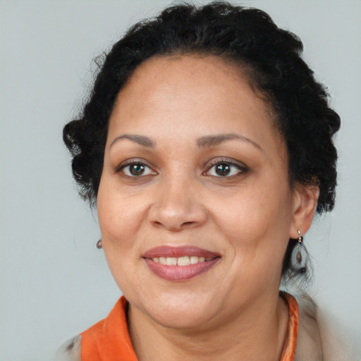 Joyful black adult female with short  brown hair and brown eyes