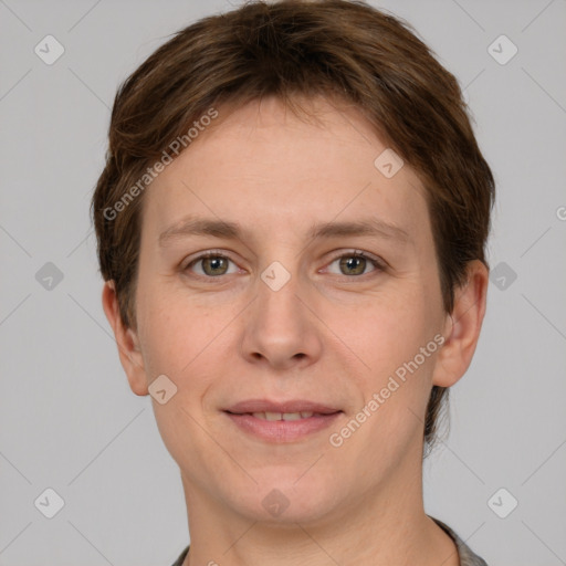 Joyful white young-adult female with short  brown hair and grey eyes