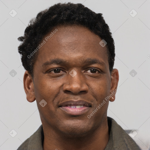 Joyful black young-adult male with short  brown hair and brown eyes