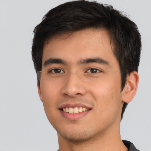 Joyful asian young-adult male with short  brown hair and brown eyes
