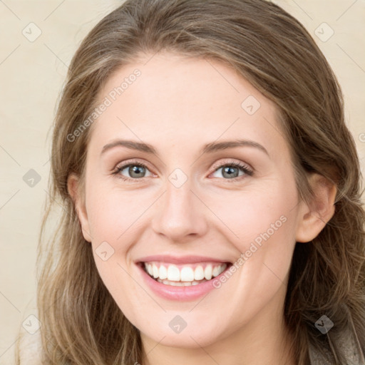 Joyful white young-adult female with long  brown hair and green eyes