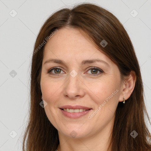 Joyful white adult female with long  brown hair and brown eyes