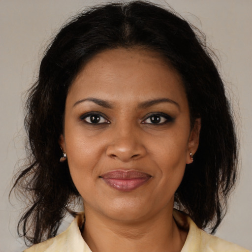 Joyful black young-adult female with medium  brown hair and brown eyes