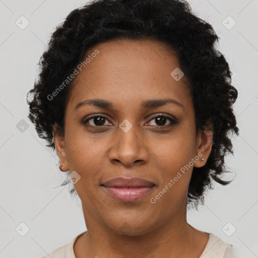 Joyful black adult female with short  brown hair and brown eyes