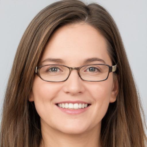 Joyful white young-adult female with long  brown hair and grey eyes