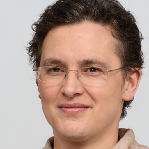 Joyful white adult male with medium  brown hair and brown eyes