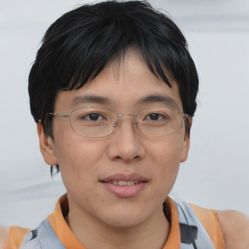 Joyful asian adult male with short  brown hair and brown eyes