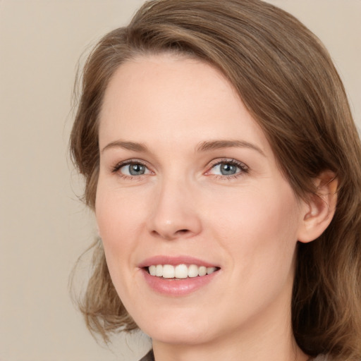 Joyful white young-adult female with medium  brown hair and green eyes