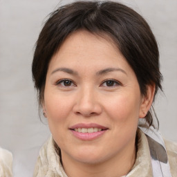 Joyful asian adult female with medium  brown hair and brown eyes