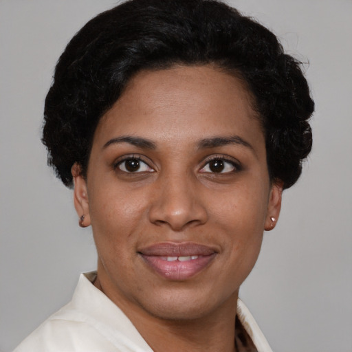 Joyful latino young-adult female with short  black hair and brown eyes