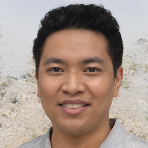 Joyful asian young-adult male with short  black hair and brown eyes