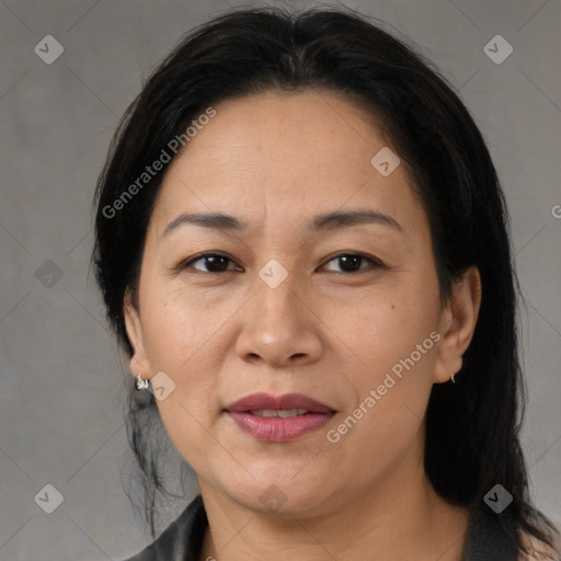 Joyful asian adult female with medium  brown hair and brown eyes