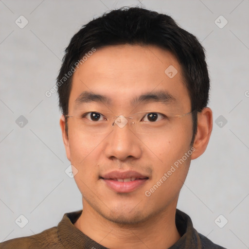 Joyful asian young-adult male with short  black hair and brown eyes