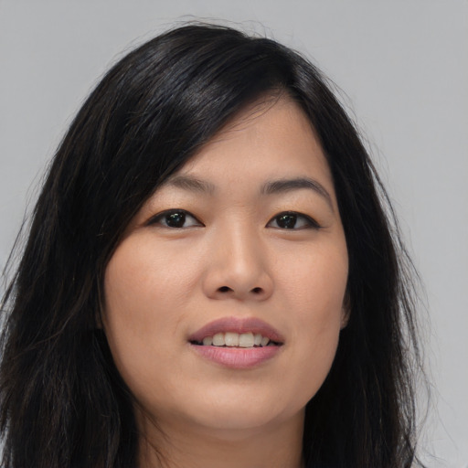 Joyful asian young-adult female with long  black hair and brown eyes