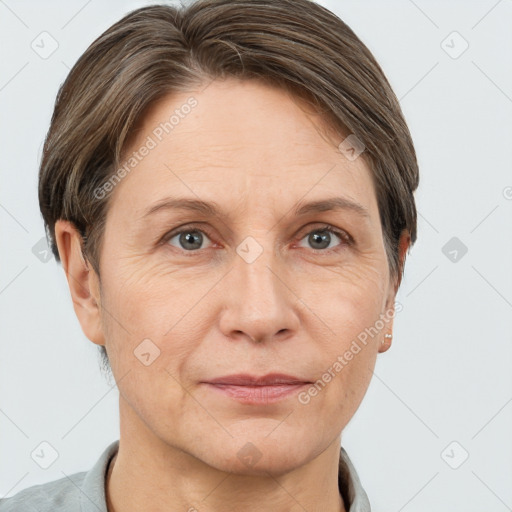 Joyful white adult female with short  brown hair and grey eyes