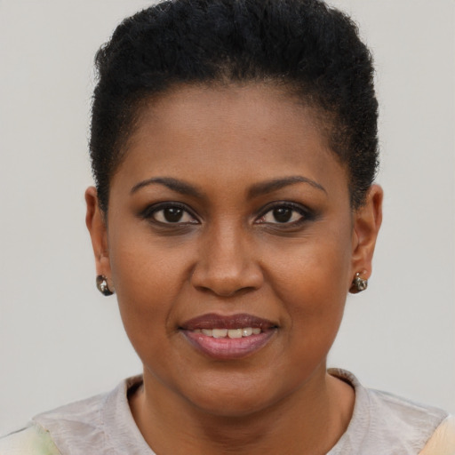 Joyful black young-adult female with short  brown hair and brown eyes