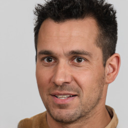 Joyful white adult male with short  brown hair and brown eyes