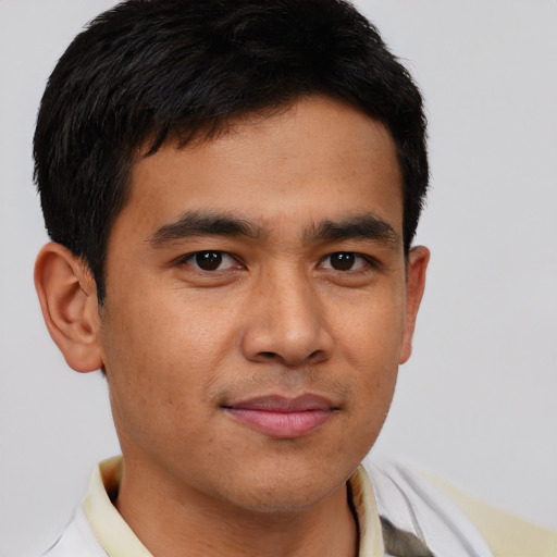 Joyful latino young-adult male with short  brown hair and brown eyes