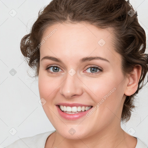 Joyful white young-adult female with medium  brown hair and green eyes