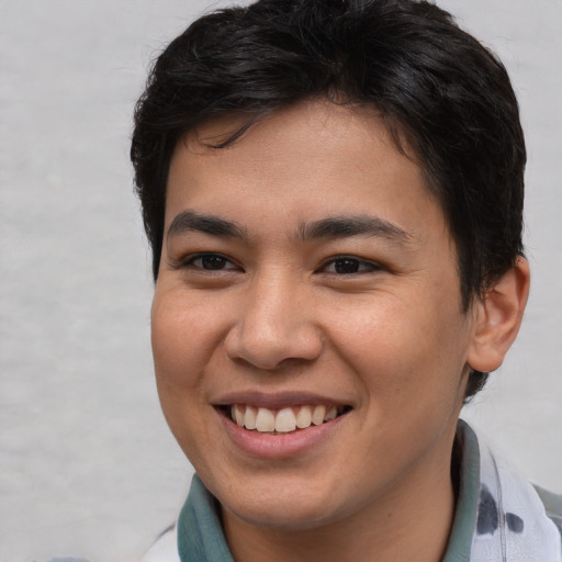 Joyful asian young-adult male with short  brown hair and brown eyes