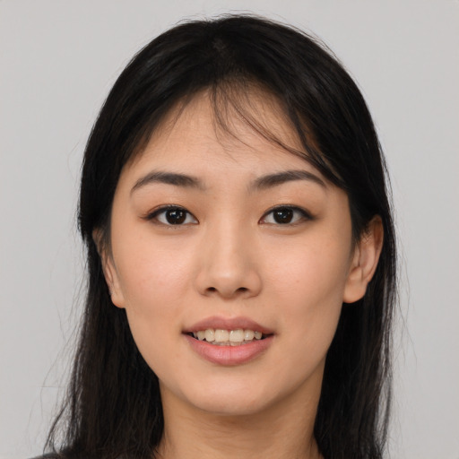 Joyful asian young-adult female with long  brown hair and brown eyes