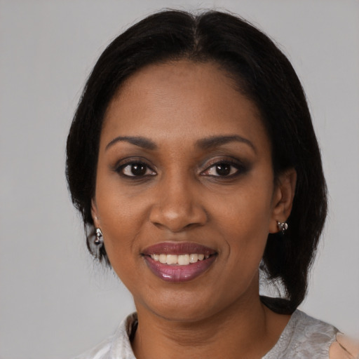 Joyful black young-adult female with medium  black hair and brown eyes