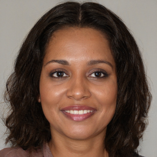 Joyful black young-adult female with medium  brown hair and brown eyes