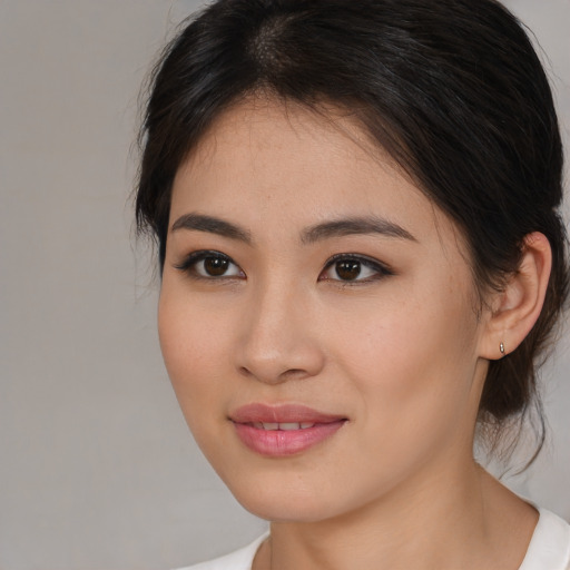 Joyful asian young-adult female with medium  brown hair and brown eyes