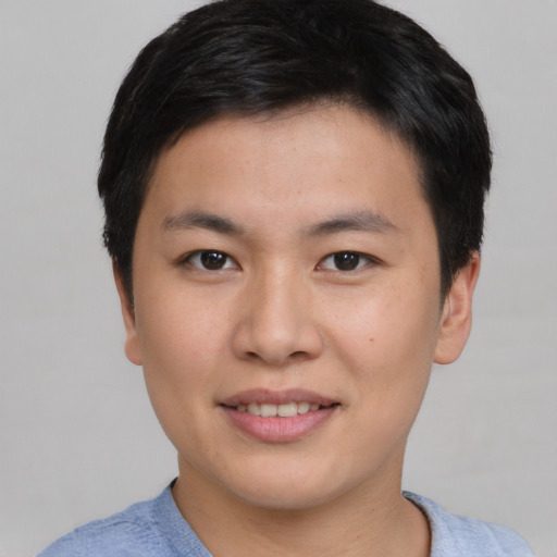 Joyful asian young-adult male with short  brown hair and brown eyes