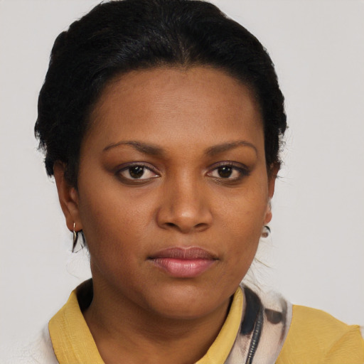 Joyful black young-adult female with short  brown hair and brown eyes