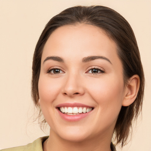 Joyful white young-adult female with medium  brown hair and brown eyes