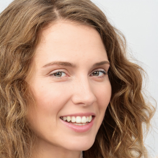 Joyful white young-adult female with long  brown hair and green eyes