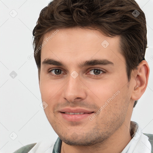 Joyful white young-adult male with short  brown hair and brown eyes