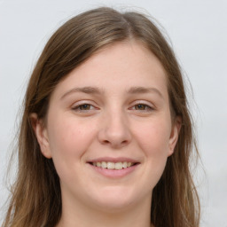 Joyful white young-adult female with long  brown hair and green eyes