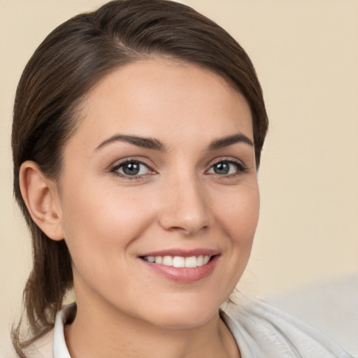 Joyful white young-adult female with medium  brown hair and brown eyes