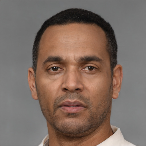 Neutral latino adult male with short  black hair and brown eyes