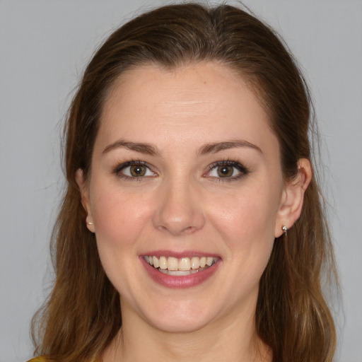 Joyful white young-adult female with medium  brown hair and blue eyes