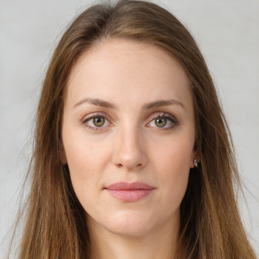 Joyful white young-adult female with long  brown hair and green eyes