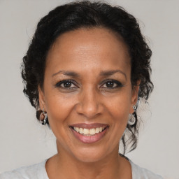 Joyful black adult female with medium  brown hair and brown eyes